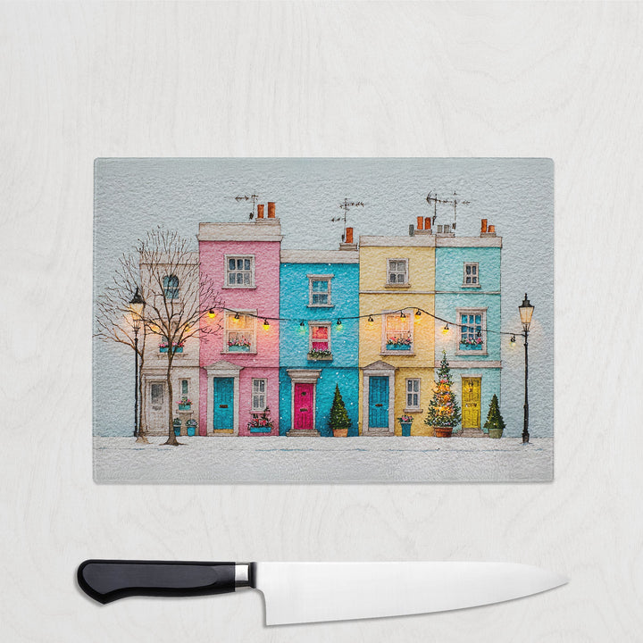 Colorful row of houses on a glass panel with a knife below