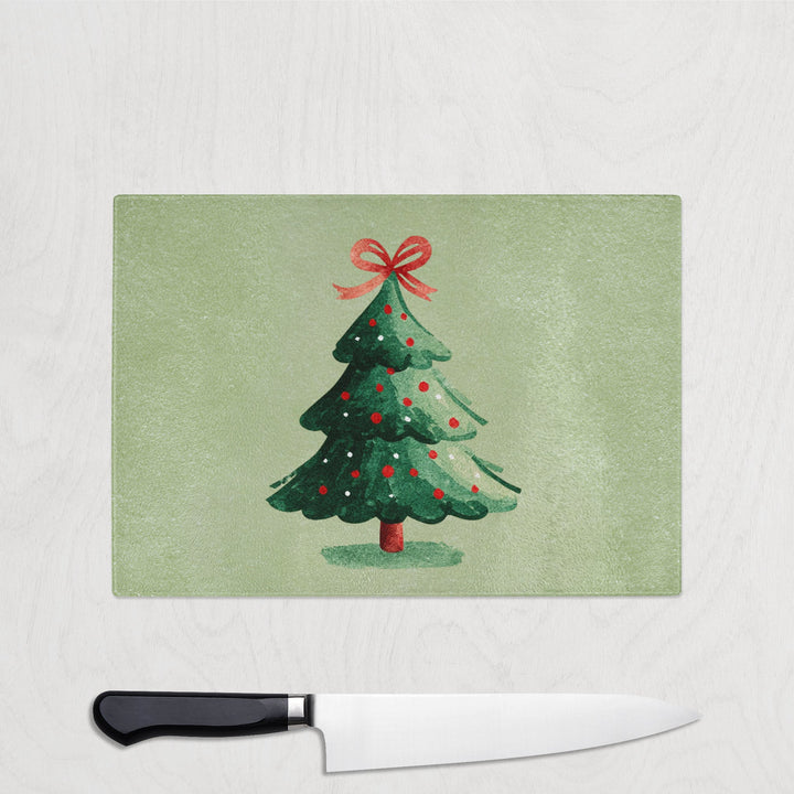 Christmas tree design on a placemat with a knife below on a white background