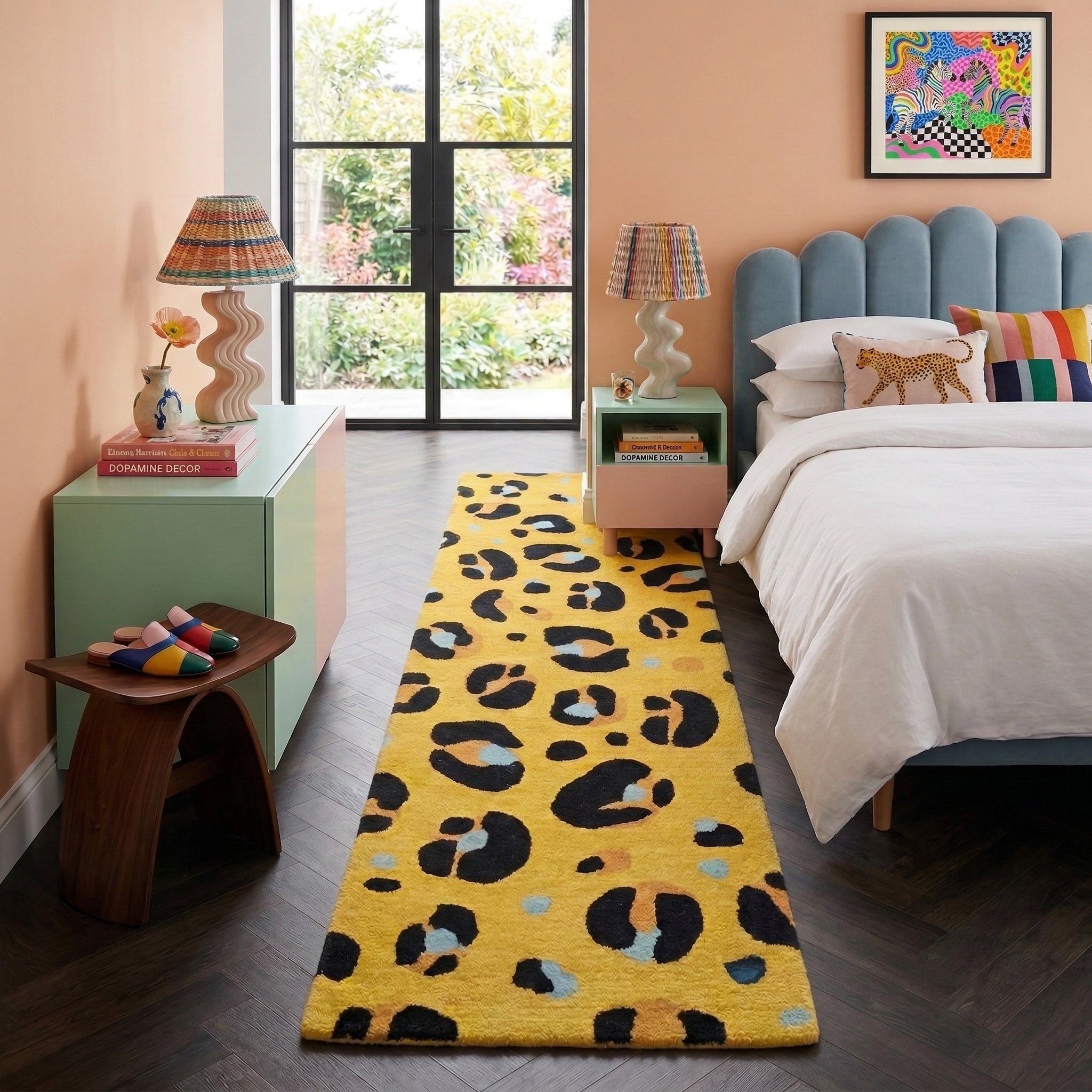 Modern bedroom with a yellow leopard print rug, bed, and side tables.