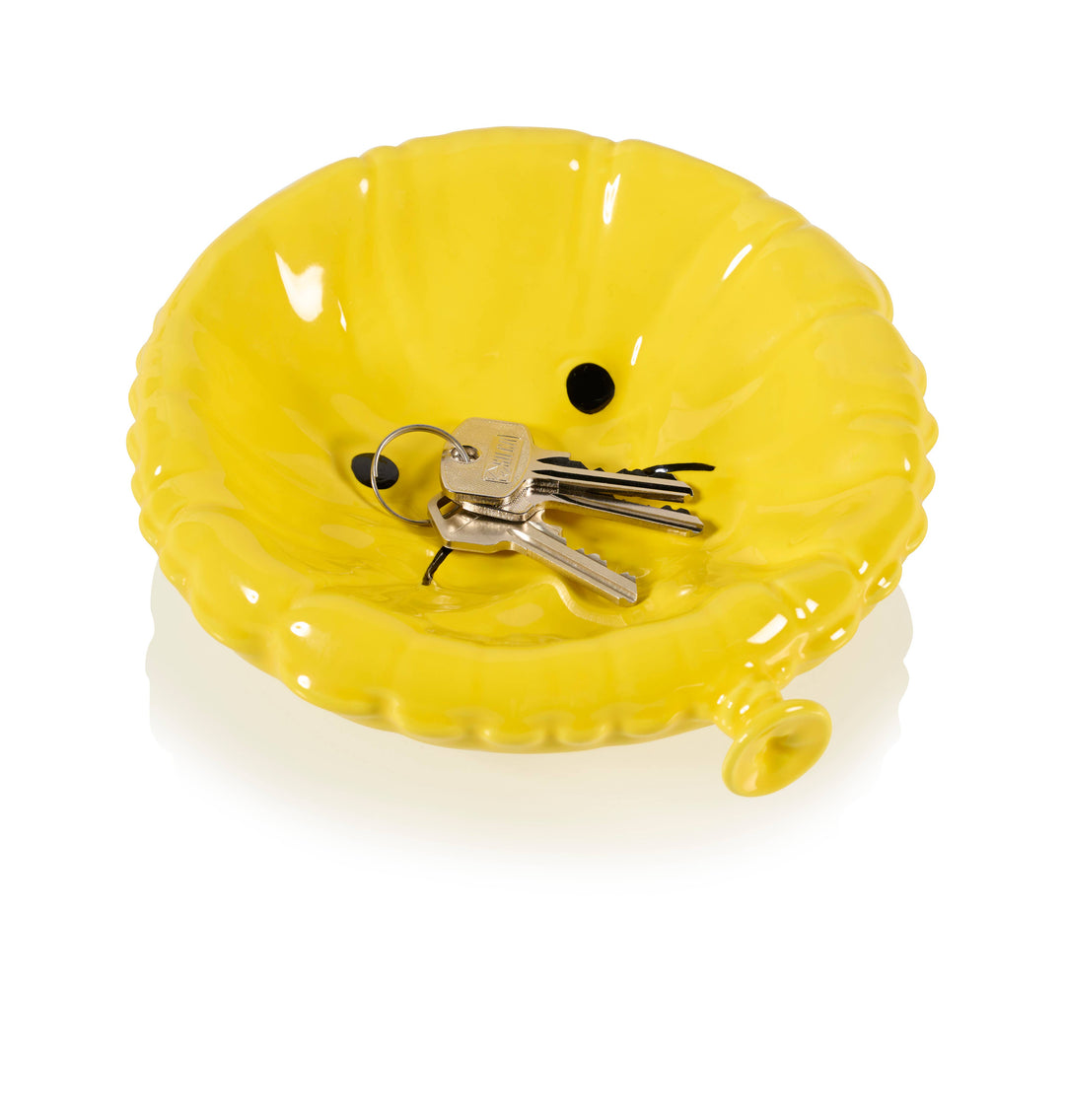 Yellow key holder with keys on a white background