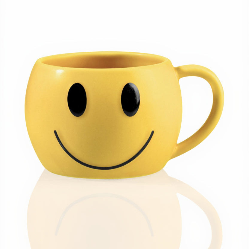 Yellow mug with a smiley face design on a white background