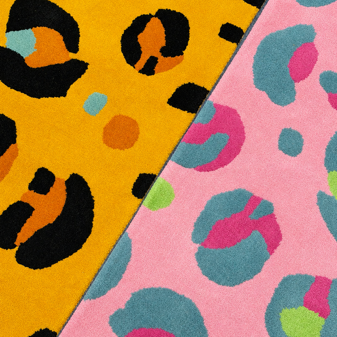 Two colorful leopard print rugs with animal print patterns, one electric yellow and orange and black, the other pink and blue.