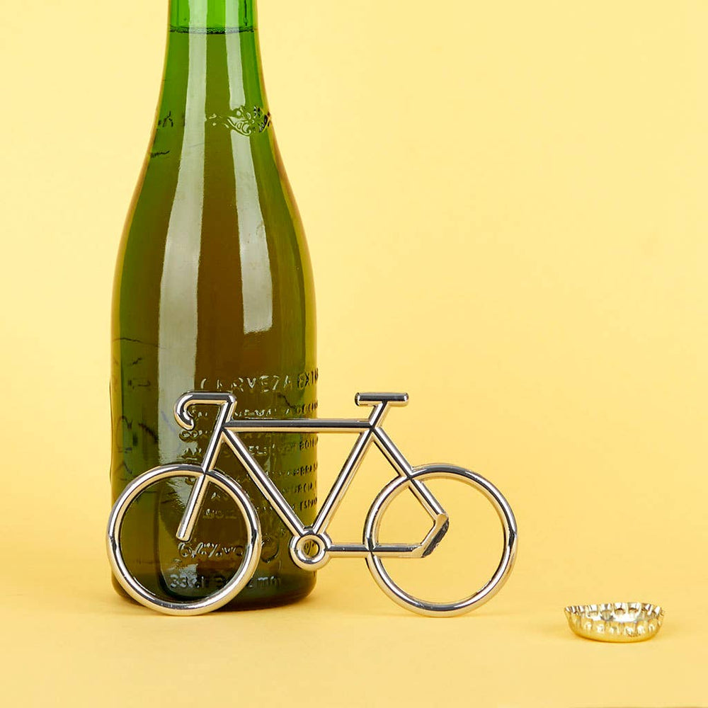Bottle of wine with a bicycle-shaped bottle opener on a yellow background