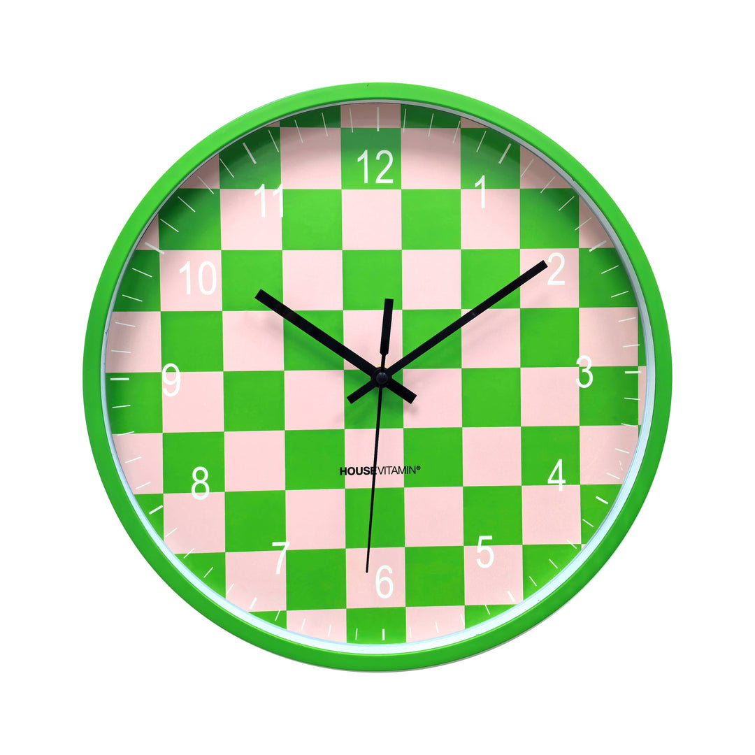 Green and pink checkerboard wall clock with black hands and modern design