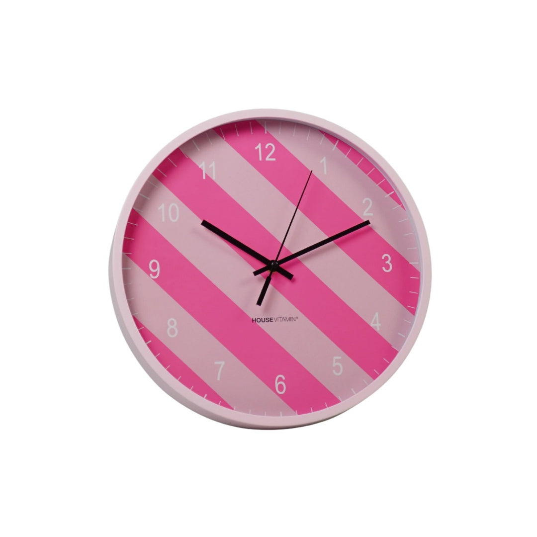 Neon pink striped wall clock with black hands and bold modern design
