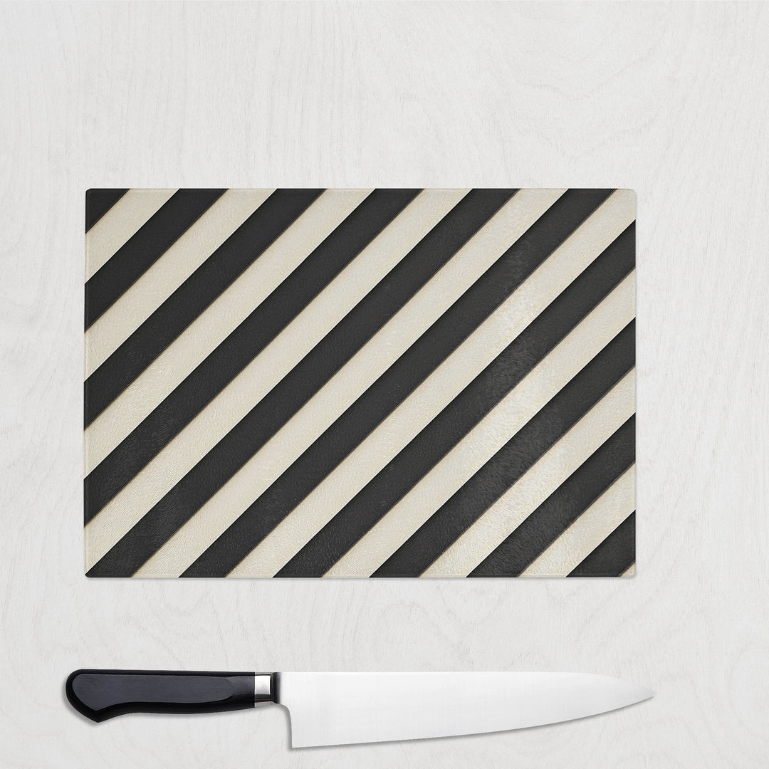 Black and cream diagonal striped glass chopping board called Parallel Noir