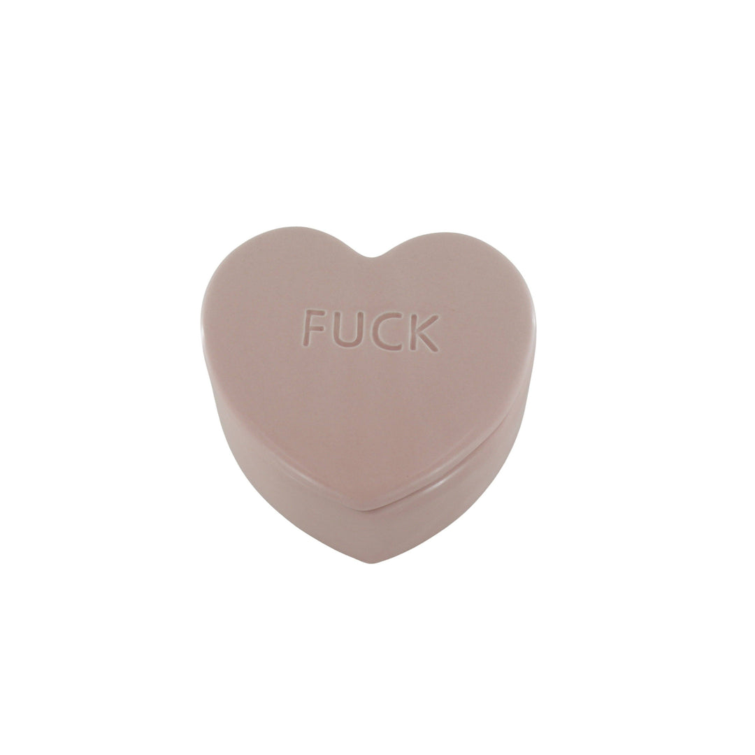 Heart-shaped object with 'FUCK' printed on it against a white background