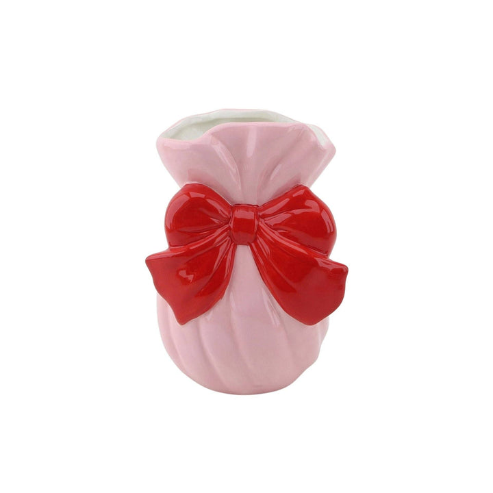 Pink vase with a red bow on a white background