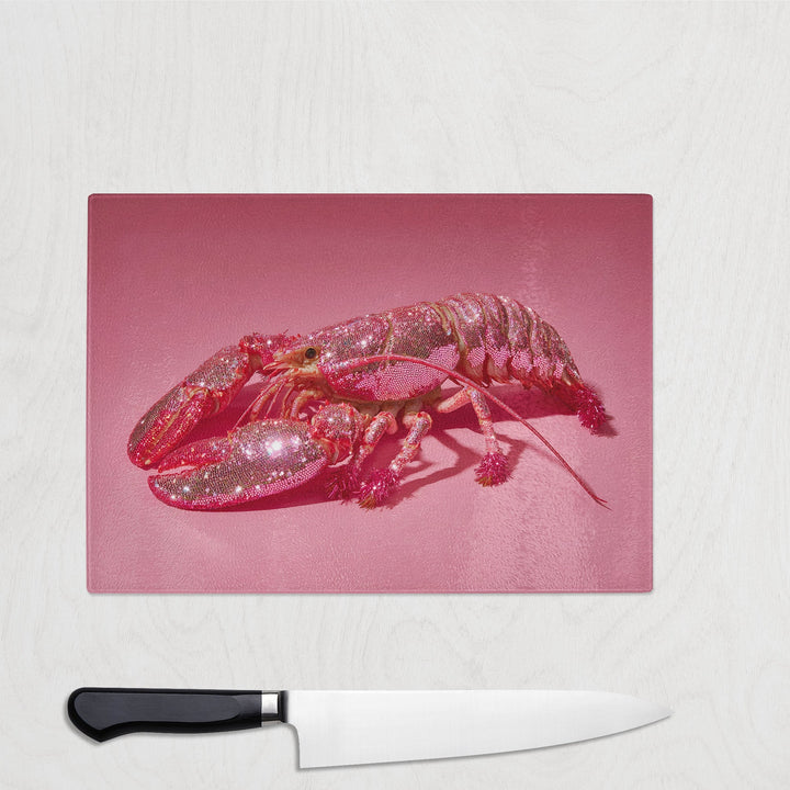 Pink glitter lobster on a bright pink background printed on a glass chopping board – bold, quirky, and fun kitchen decor.