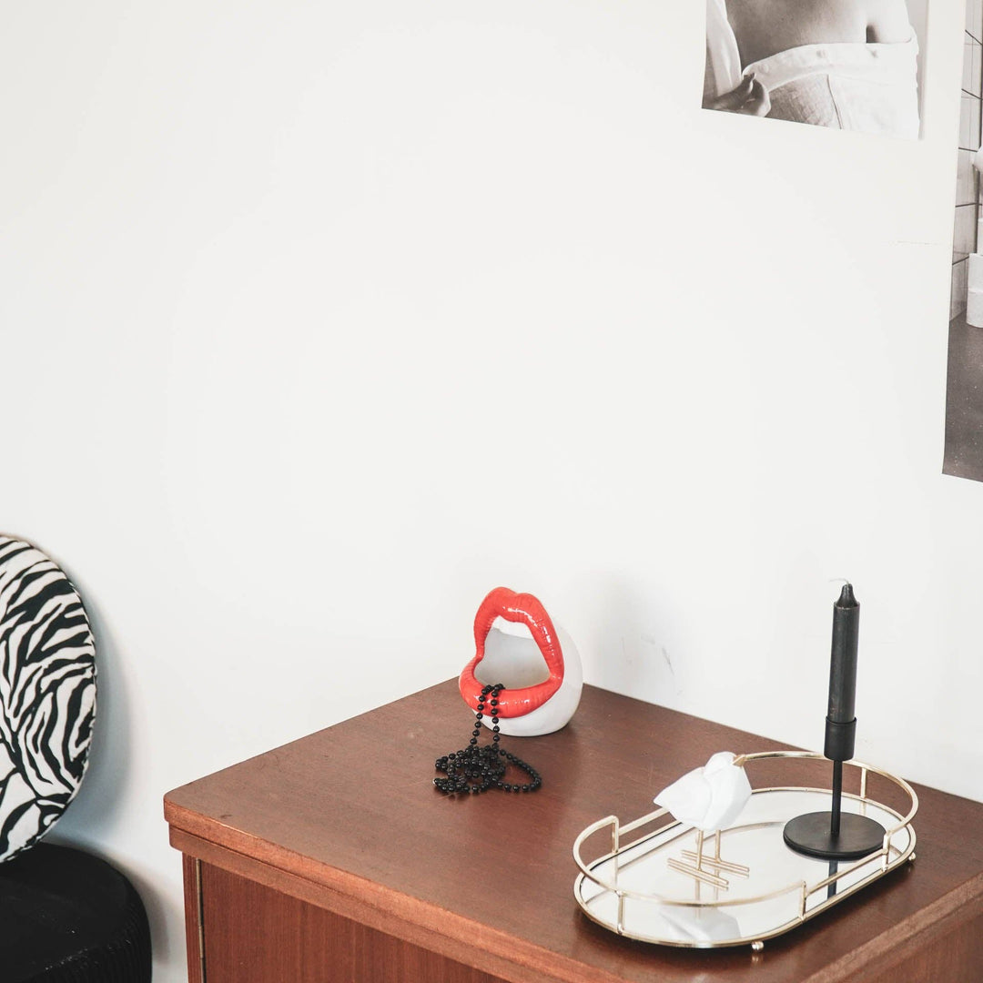 Decorative items on a wooden surface with a white wall background