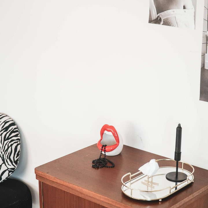 Decorative items on a wooden surface with a white wall background