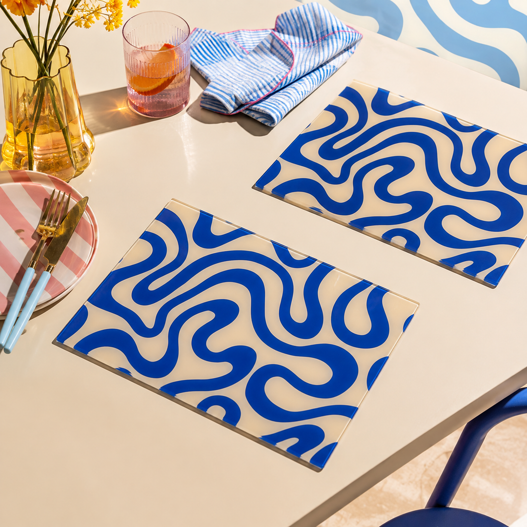 Yililo Blue Wiggle Funk glass placemats, printed with a retro blue wavy squiggle design.