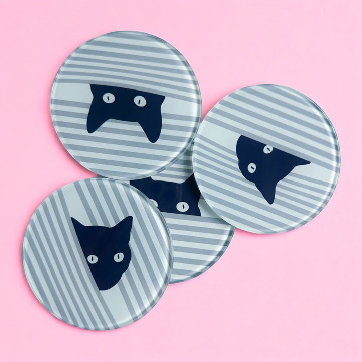Peeping Black Cat Stripe glass coasters, four round glass coasters with black cat faces peeping through grey and white diagonal stripes on light pink